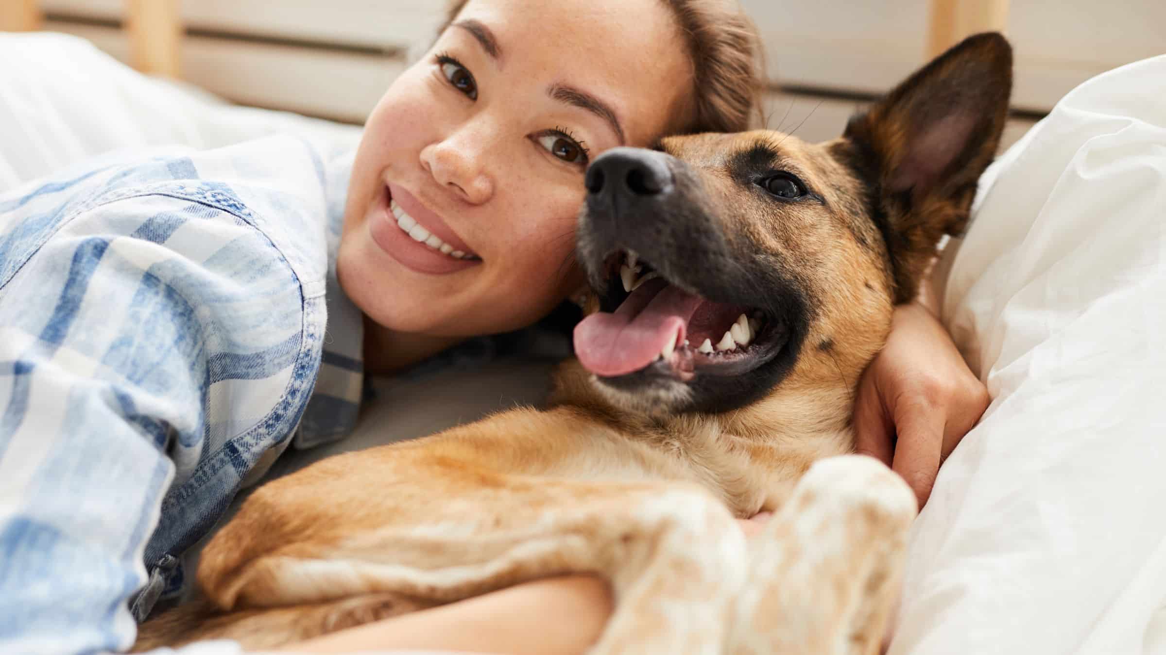 Happy Dog Owner Cuddling Her Dog